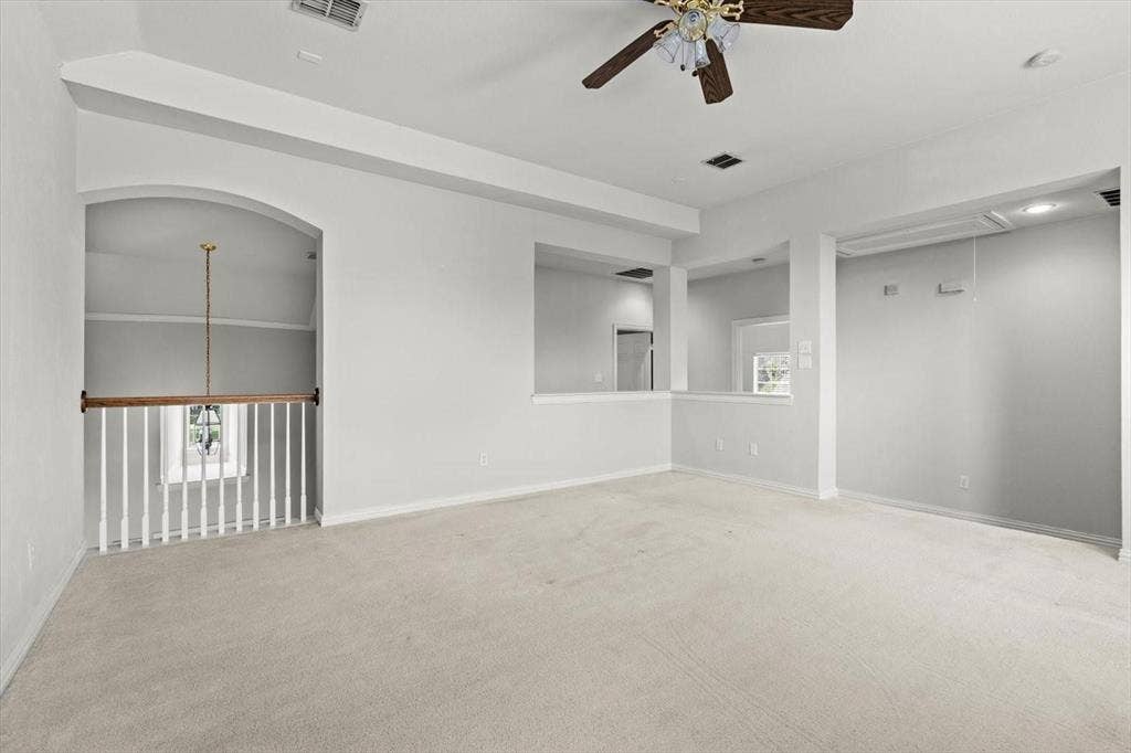 4120 Silverthorne Street, Richardson, TX 75082 Vaulted ceilings, carpeted flooring, wall-cutout architectural features, ceiling fan with light fixture, and wooden baluster railing