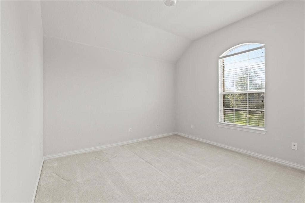 4120 Silverthorne Street, Richardson, TX 75082 Vaulted ceiling, neutral wall tones, wall-to-wall carpeting, and an arched window