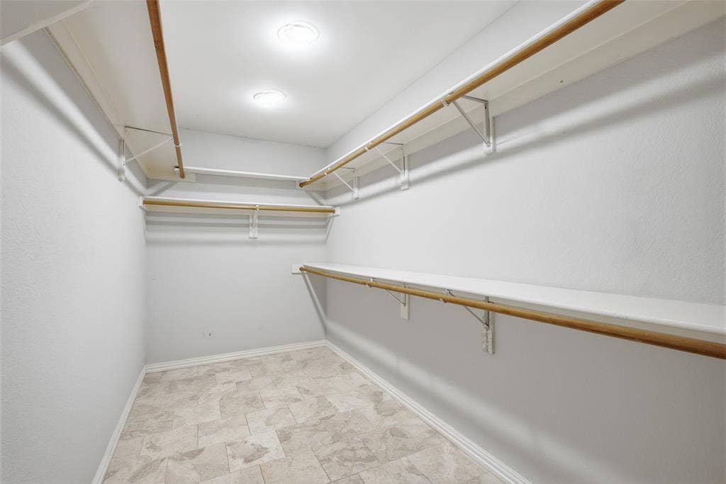 4010 Azure Lane, Addison, TX 75001 A generous walk-in closet with tile floors and double-hung rods leaves plenty of room for every season’s wardrobe.