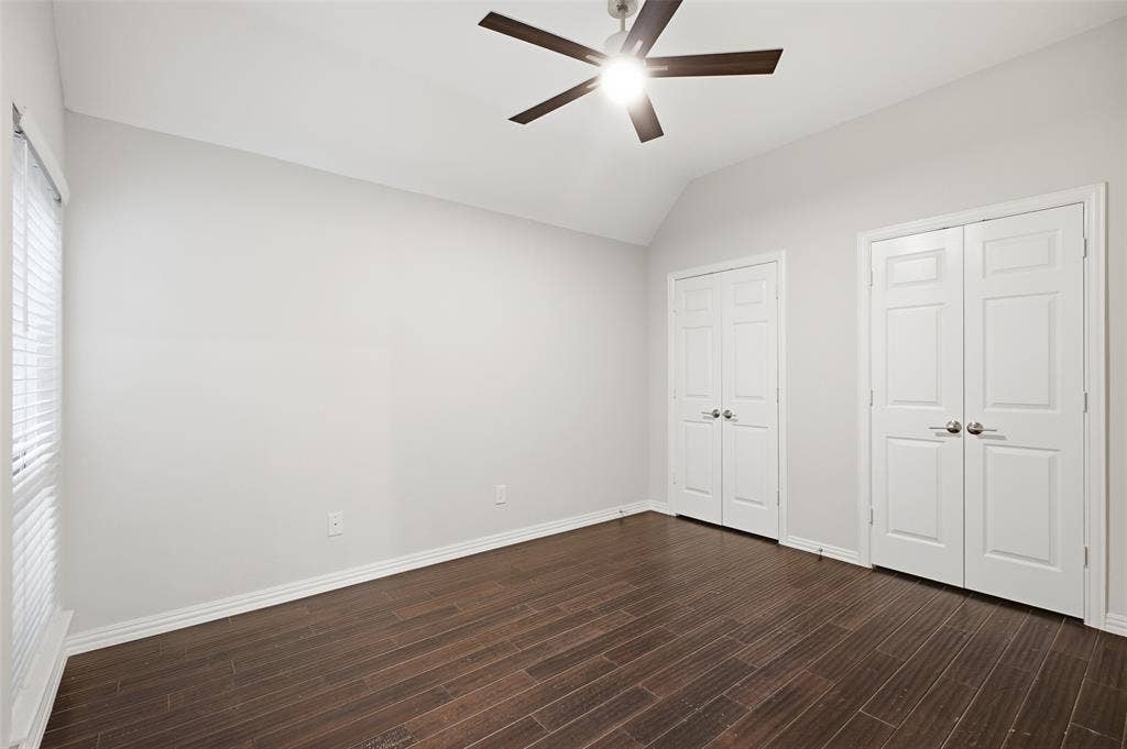 4010 Azure Lane, Addison, TX 75001 This spacious secondary bedroom has a vaulted ceiling and two double-door closets for abundant storage.