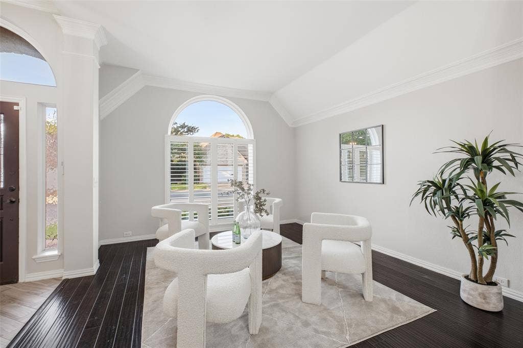 4010 Azure Lane, Addison, TX 75001 Vaulted ceilings, crown molding and an arched window with plantation shutters make the front sitting room an elegant spot for morning coffee or quiet reading.