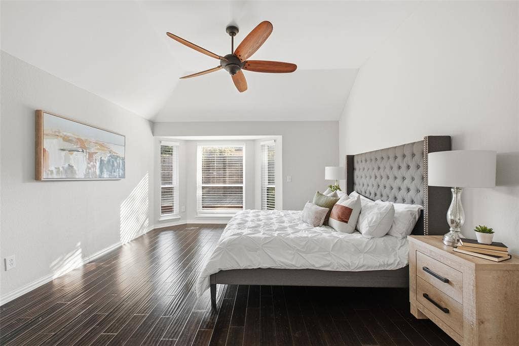 4010 Azure Lane, Addison, TX 75001 Your private retreat: the primary suite has a soaring vaulted ceiling, a sunny bay window and dark wood floors.