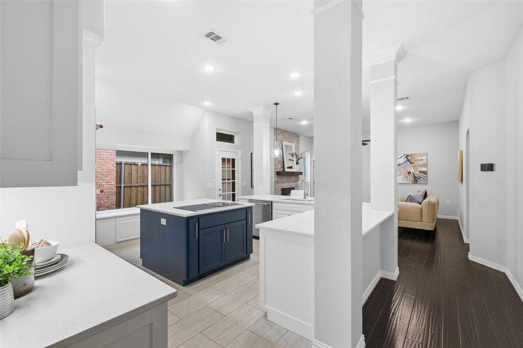 4010 Azure Lane, Addison, TX 75001 Columns frame the kitchen while keeping it open to the living area, so you can host, cook and connect without missing a moment.