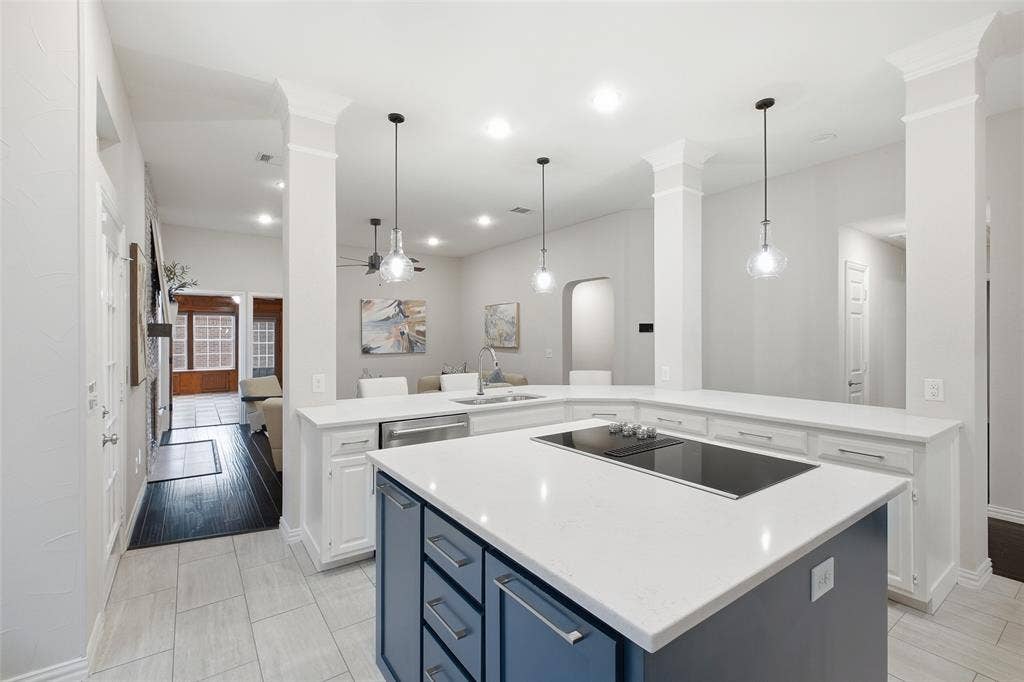 4010 Azure Lane, Addison, TX 75001 The navy center island adds a sleek cooktop and extra prep space, keeping the cook part of the conversation.