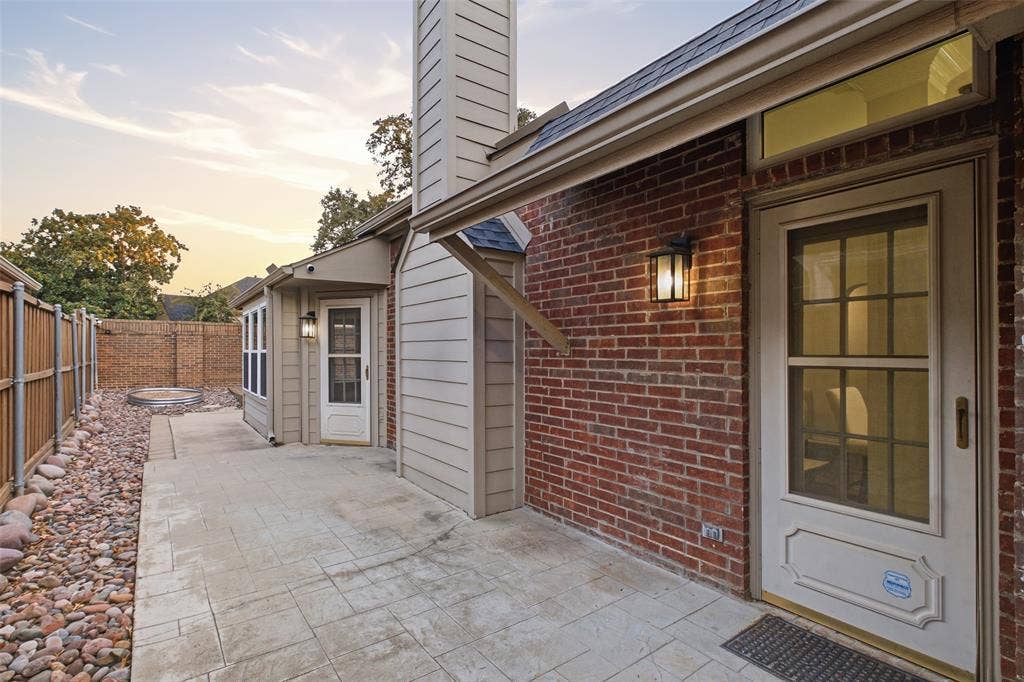 4010 Azure Lane, Addison, TX 75001 Step outside for morning coffee or evening conversation on your private patio, framed by brick and mature trees.