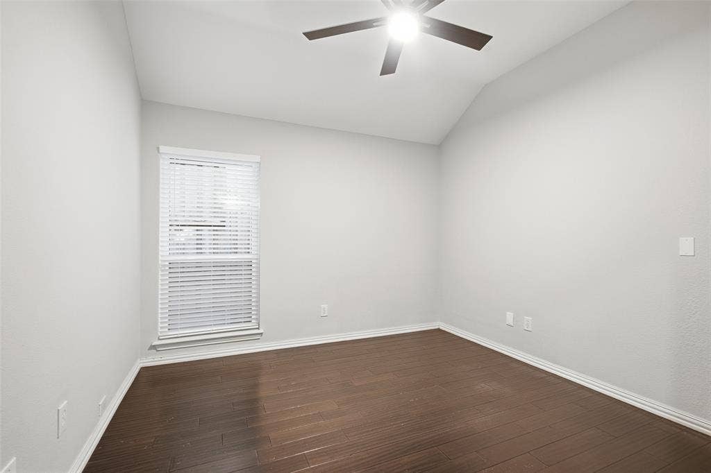 4010 Azure Lane, Addison, TX 75001 The secondary bedrooms are bright and versatile, with vaulted ceilings, ceiling fans and wood-look floors. Ideal for guests, family or a home office.