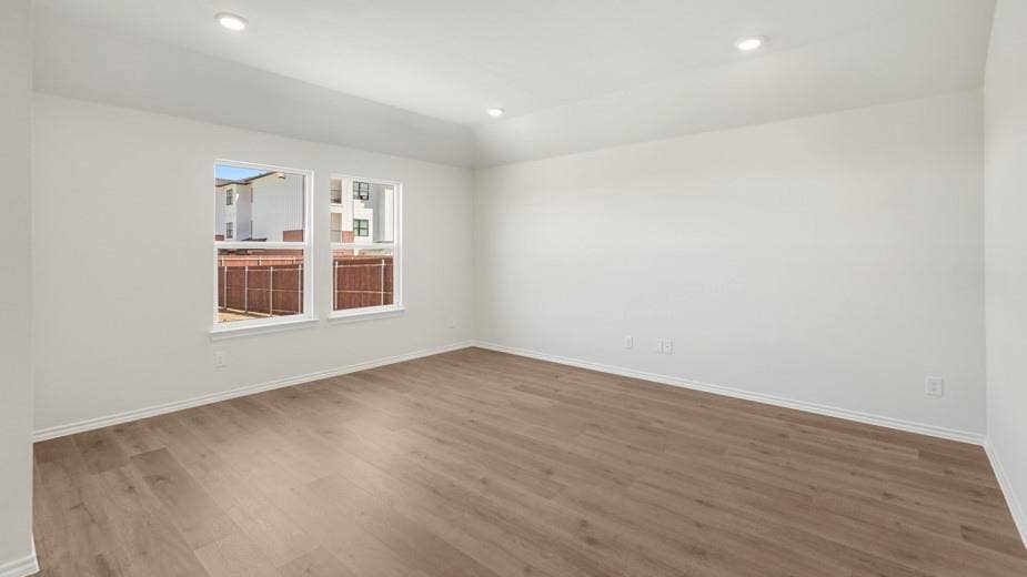 708 Rock Point Road, Josephine, TX 75135 Recessed ceiling lighting illuminates the room with wood-finish flooring and multiple windows