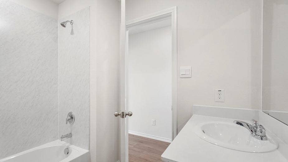 708 Rock Point Road, Josephine, TX 75135 Contemporary bathroom featuring a white bathtub, integrated shower, chrome fixtures, and a vanity with an integrated sink