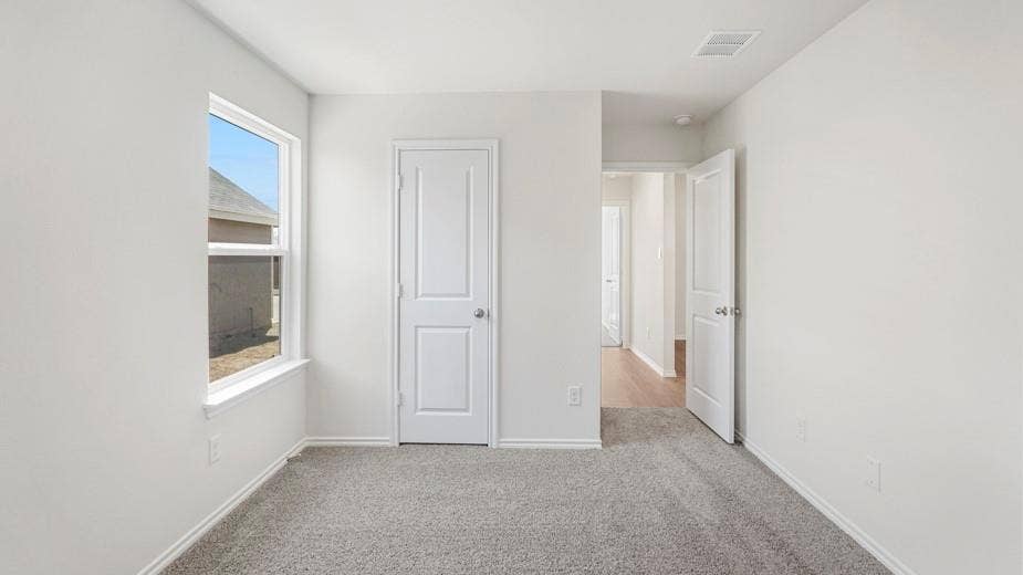 708 Rock Point Road, Josephine, TX 75135 Wall-to-wall carpeting, white interior paint, white trim, white door with silver-tone hardware, and a window with white framing
