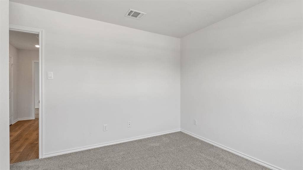 Room featuring light gray carpeting, white painted walls, and white baseboards