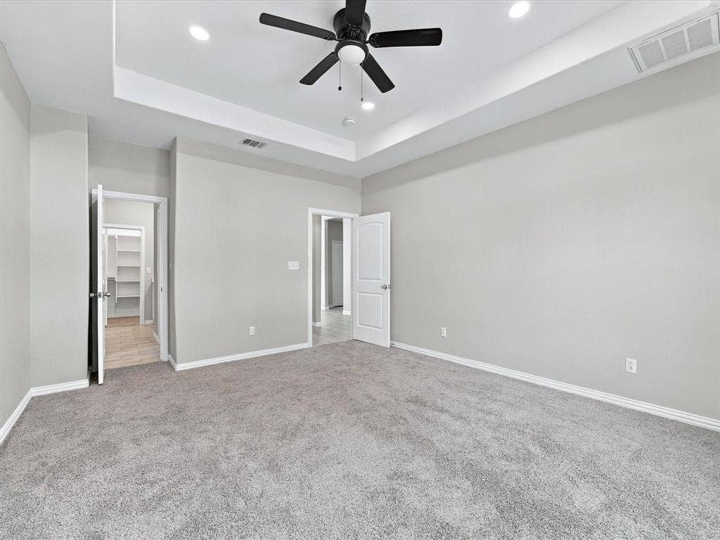 2312 Rogers Avenue, Lancaster, TX 75134 Room featuring a tray ceiling, recessed lighting, neutral carpeting, and a multi-blade ceiling fan