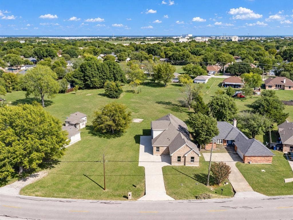 2312 Rogers Avenue, Lancaster, TX 75134 Expansive parcel featuring a brick exterior residence, concrete driveway, and abundant mature trees