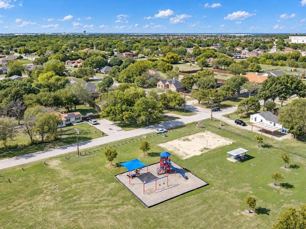 2312 Rogers Avenue, Lancaster, TX 75134 Expansive open green space featuring a playground with shade structures, a sand court, and a covered picnic area