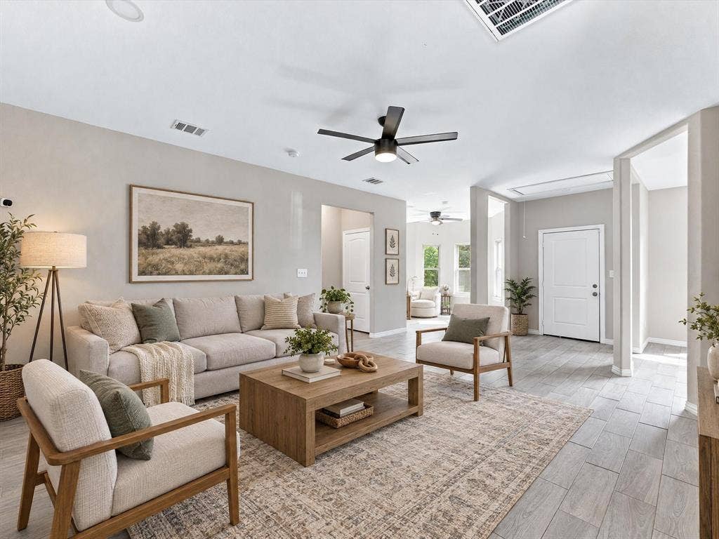 2312 Rogers Avenue, Lancaster, TX 75134 Virtually staged open-concept interior featuring light-toned wood-finish flooring, recessed lighting, neutral wall paint, and a modern ceiling fan