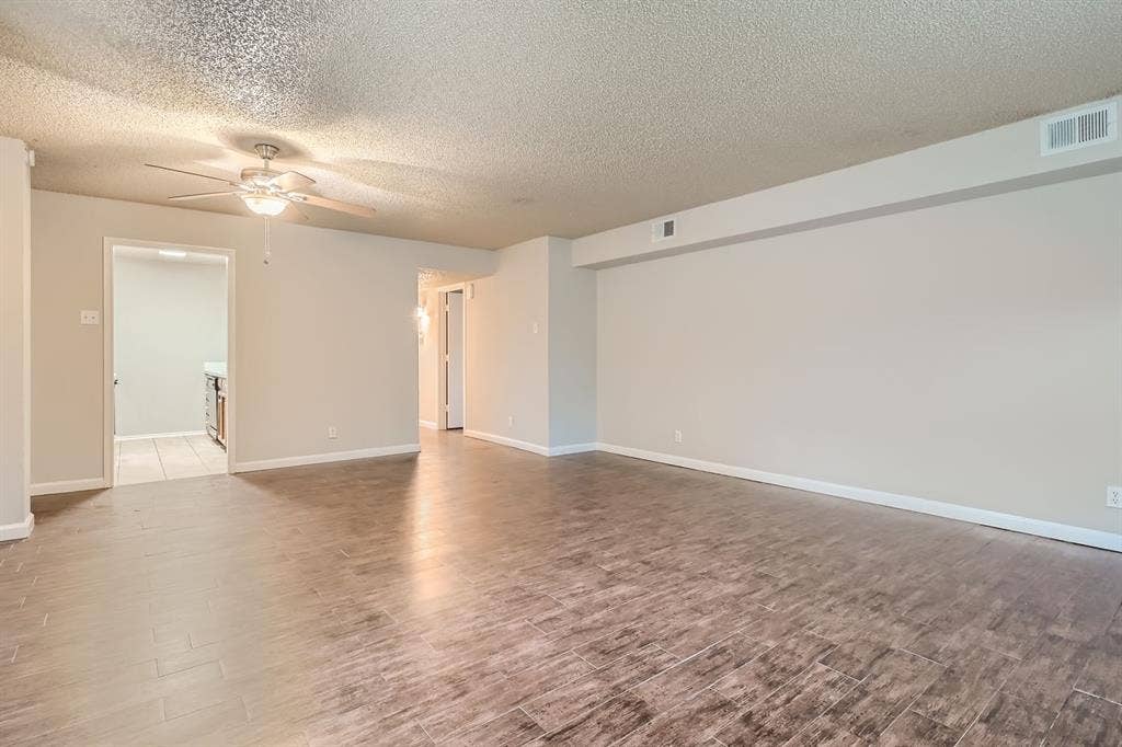 806 Prairie Creek Drive, Princeton, TX 75407 Open-concept room featuring wood-finish flooring, a ceiling fan with integrated lighting, and neutral wall paint
