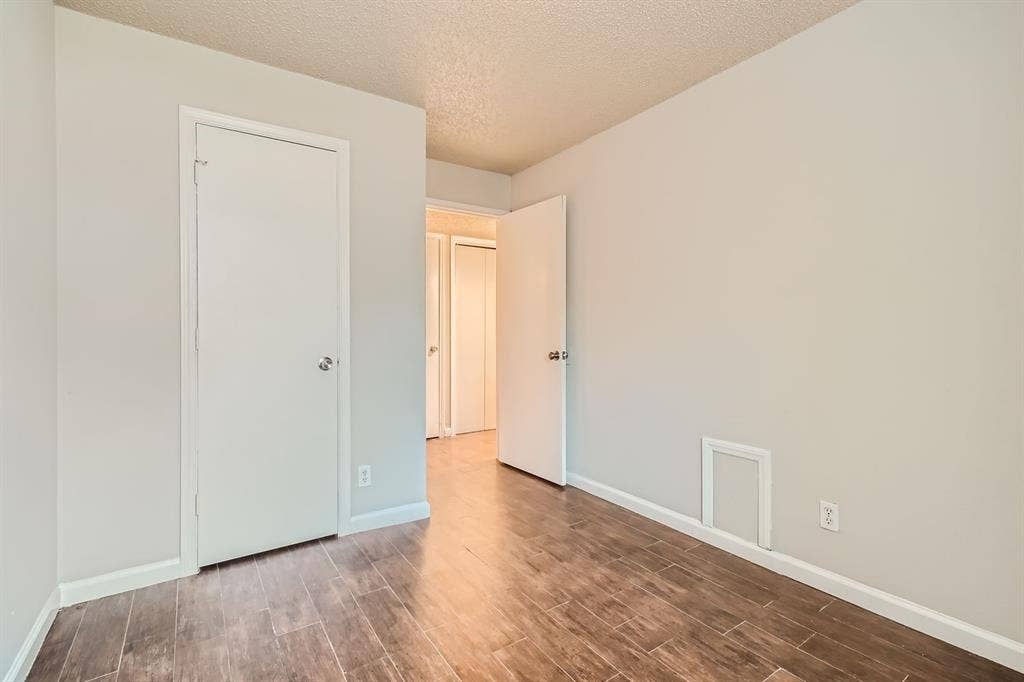 806 Prairie Creek Drive, Princeton, TX 75407 Neutral-toned interior space featuring wood-finish tile flooring and interior swing doors