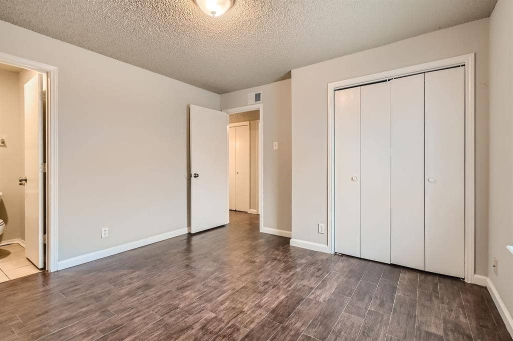 806 Prairie Creek Drive, Princeton, TX 75407 Neutral-toned interior space featuring wood-finish flooring, a bi-fold closet, and ceiling-mounted light fixture
