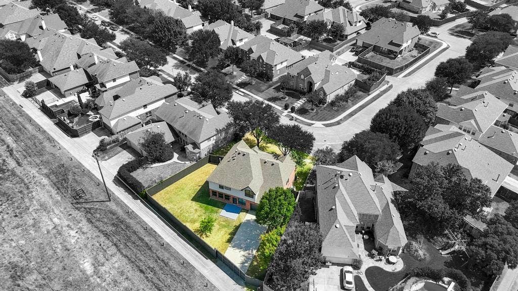 4421 Red Barn, Richardson, TX 75082 Aerial perspective of a multi-story residence situated on a corner lot featuring a fenced backyard, mature trees, and concrete driveway