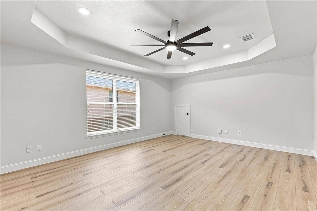 4421 Red Barn, Richardson, TX 75082 Tray ceiling featuring recessed lighting, multi-blade ceiling fan, and wood-finish flooring