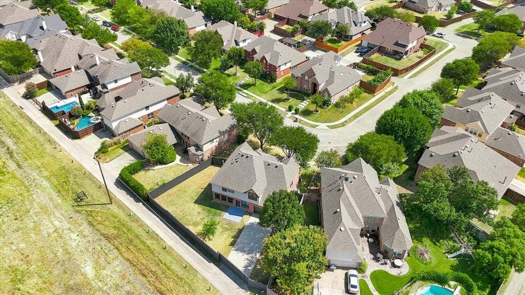 4421 Red Barn, Richardson, TX 75082 Aerial perspective of a residential neighborhood featuring multi-story dwellings, paved roadways, mature trees, and landscaped grounds