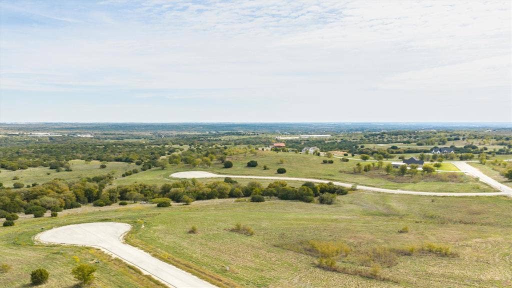 3337 Bounty Drive, Cresson, TX 76035 Expansive undeveloped acreage featuring rolling terrain, clusters of mature trees, paved cul-de-sacs, and wide-reaching territorial horizons