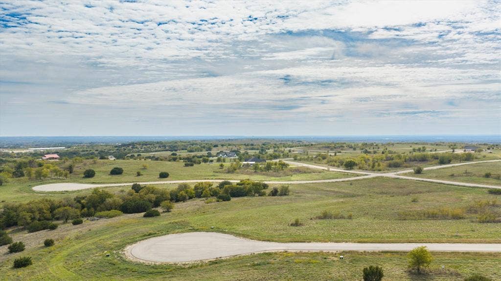3337 Bounty Drive, Cresson, TX 76035 Elevated land parcel featuring rolling topography, native vegetation, scattered mature trees, and paved cul-de-sac infrastructure