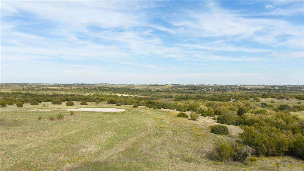 3337 Bounty Drive, Cresson, TX 76035 Expansive, undeveloped acreage featuring rolling terrain, native grasses, and clusters of mature trees