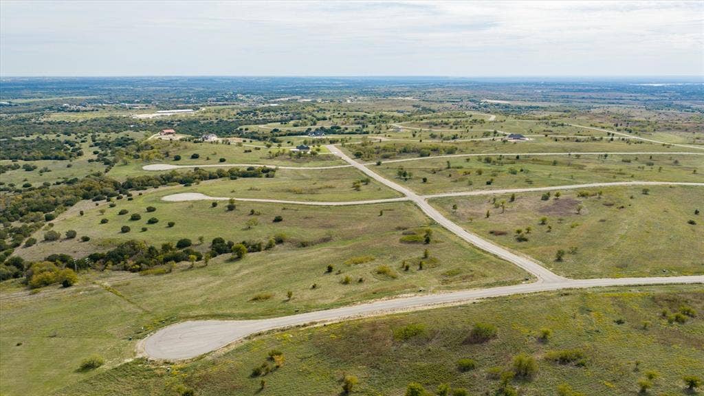3337 Bounty Drive, Cresson, TX 76035 Aerial perspective of expansive acreage featuring paved cul-de-sacs, rolling topography, and native vegetation
