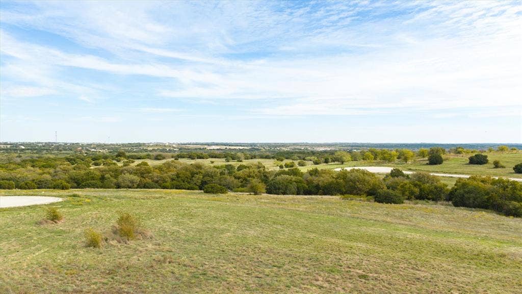 3337 Bounty Drive, Cresson, TX 76035 Expansive acreage featuring rolling terrain, clusters of mature trees, and a horizon backdrop