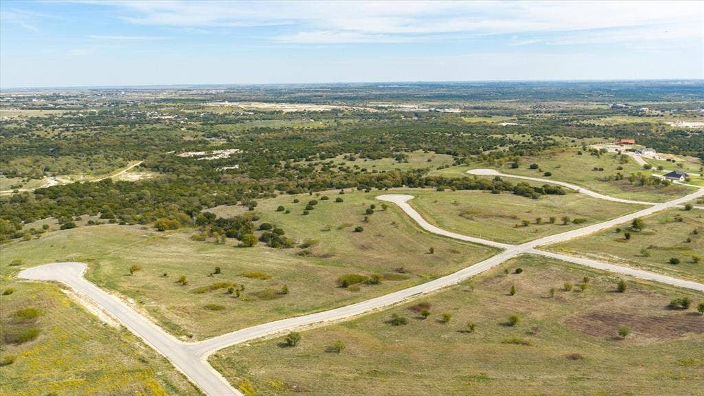 3337 Bounty Drive, Cresson, TX 76035 Aerial perspective of expansive undeveloped land featuring rolling topography, paved cul-de-sacs, and mature native vegetation