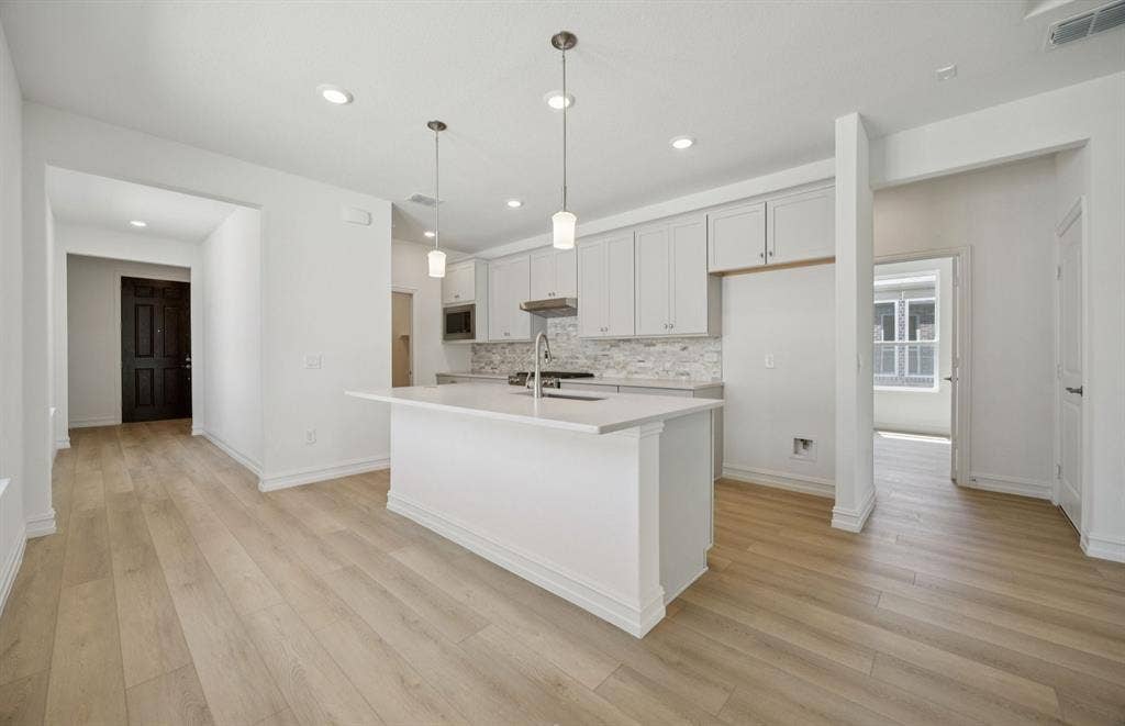 205 Snowbird Way, McKinney, TX 75071 *Floorplan representation, not actual home - Spacious kitchen with eat-in bartop island