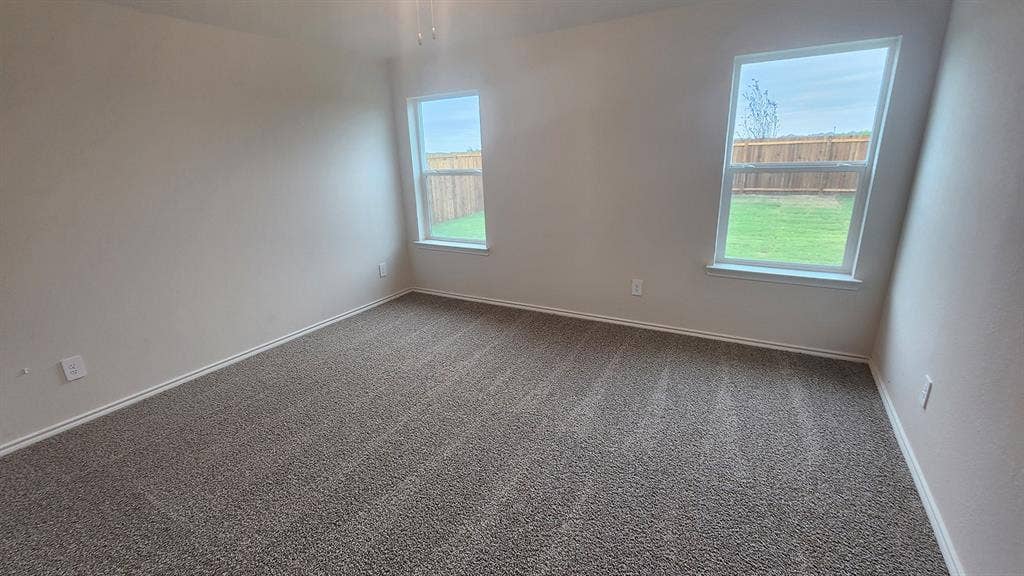 Neutral-toned walls and plush gray carpeting