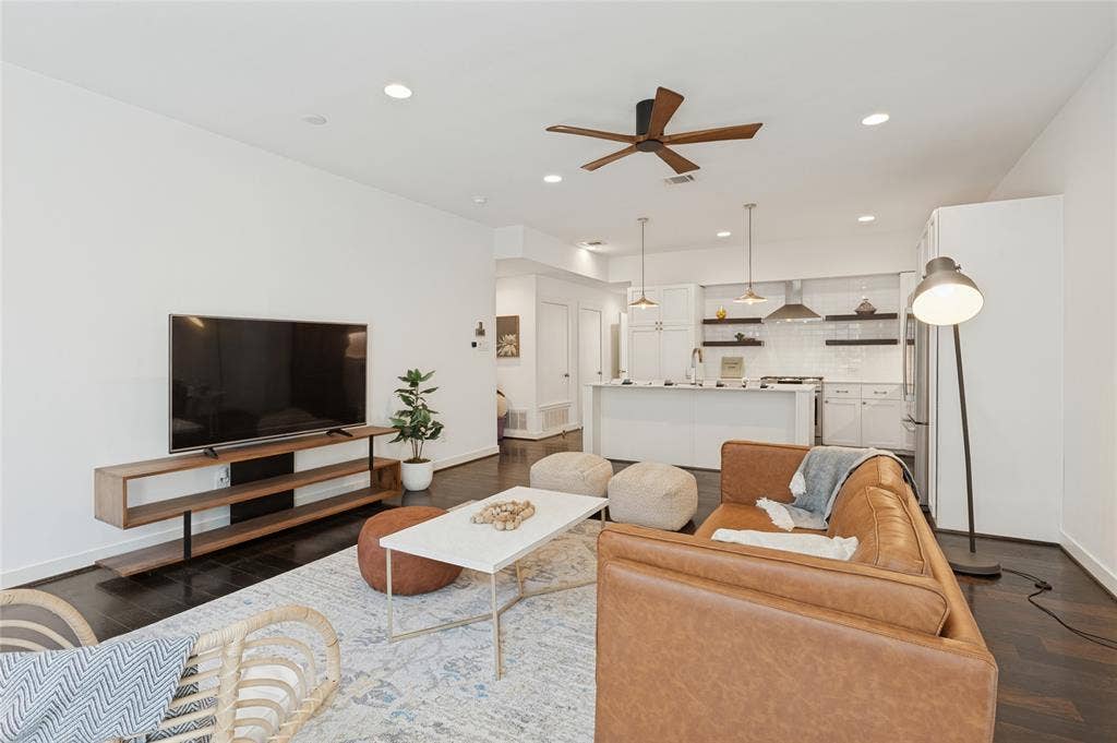 614 Finley Court, Dallas, TX 75208 Open-concept living space featuring wood-finish flooring, recessed lighting, a ceiling fan, and a kitchen island with pendant lighting