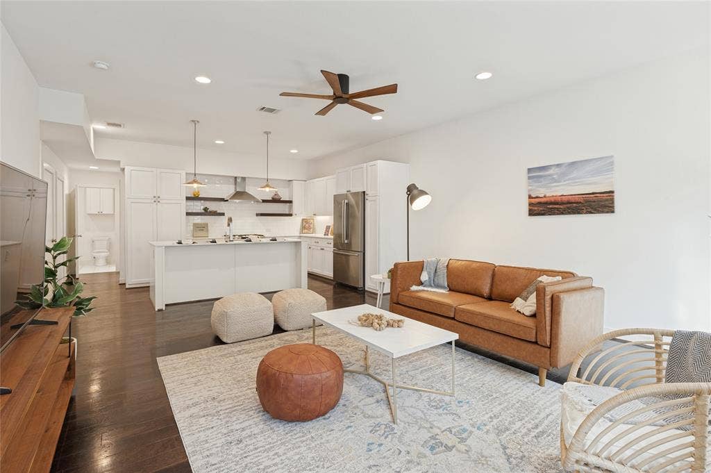 614 Finley Court, Dallas, TX 75208 Open-concept kitchen featuring white shaker-style cabinetry, stainless steel appliances, a central island, and wood-finish flooring