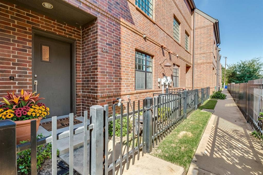 614 Finley Court, Dallas, TX 75208 Red brick exterior, metal entry door, multi-pane windows, and fenced front entryway