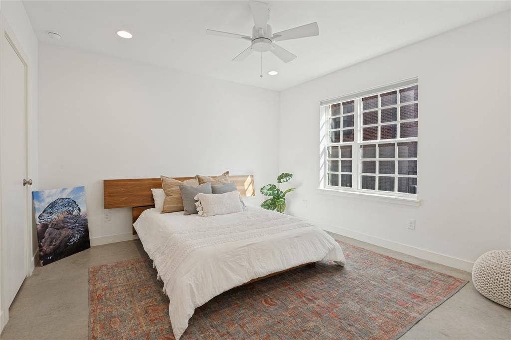 614 Finley Court, Dallas, TX 75208 Polished concrete flooring, recessed lighting, white multi-pane window, and a built-in horizontal wood-finish headboard