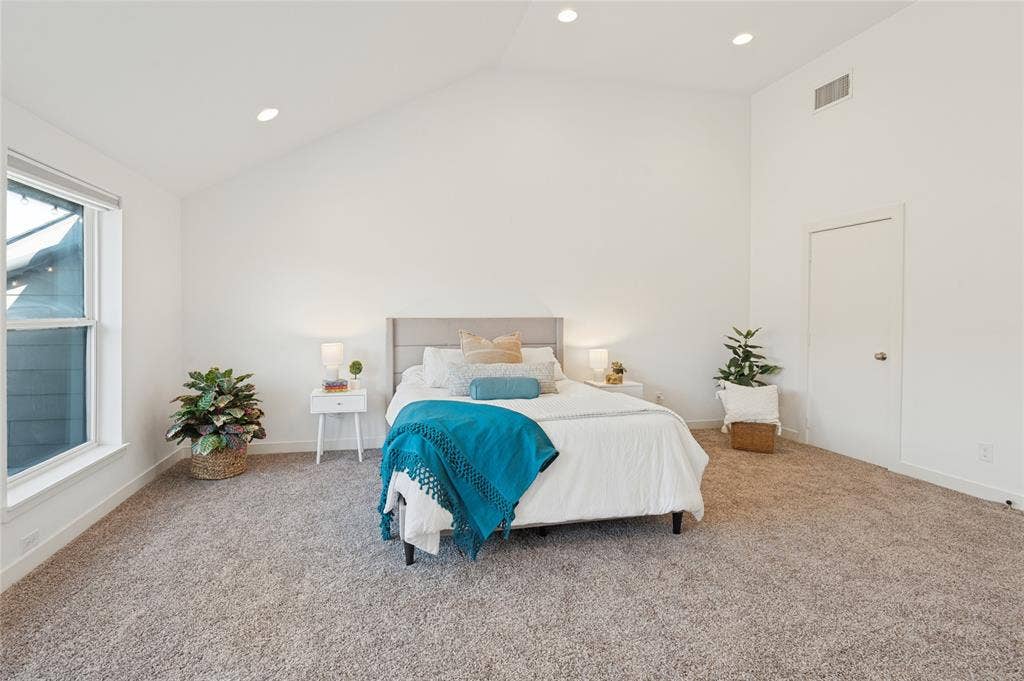 614 Finley Court, Dallas, TX 75208 Vaulted ceilings, neutral carpeting, recessed lighting, and large windows