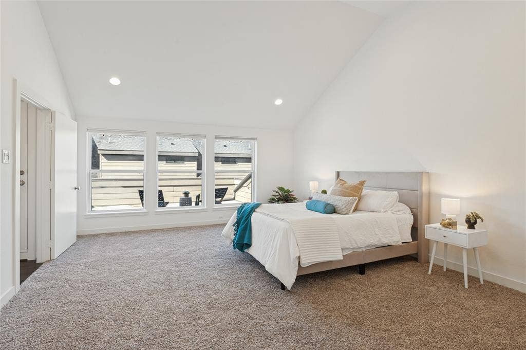 614 Finley Court, Dallas, TX 75208 Vaulted ceiling, neutral wall tones, wall-to-wall carpeting, and large multi-pane windows