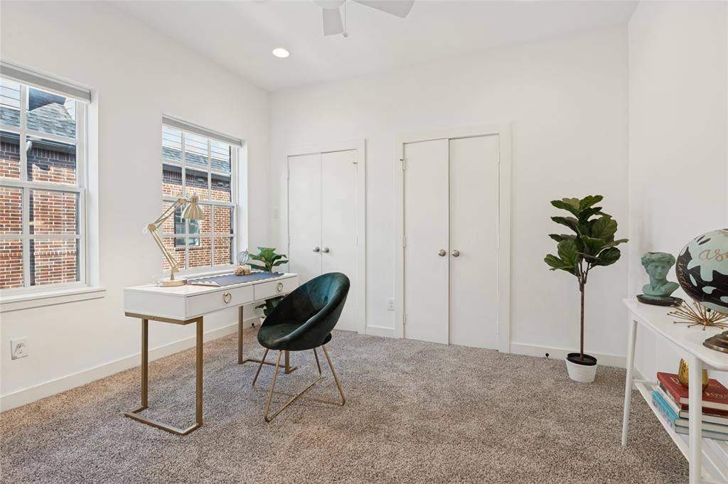 614 Finley Court, Dallas, TX 75208 Room featuring neutral wall tones, wall-to-wall carpeting, dual closets with traditional doors, and large windows with integrated blinds