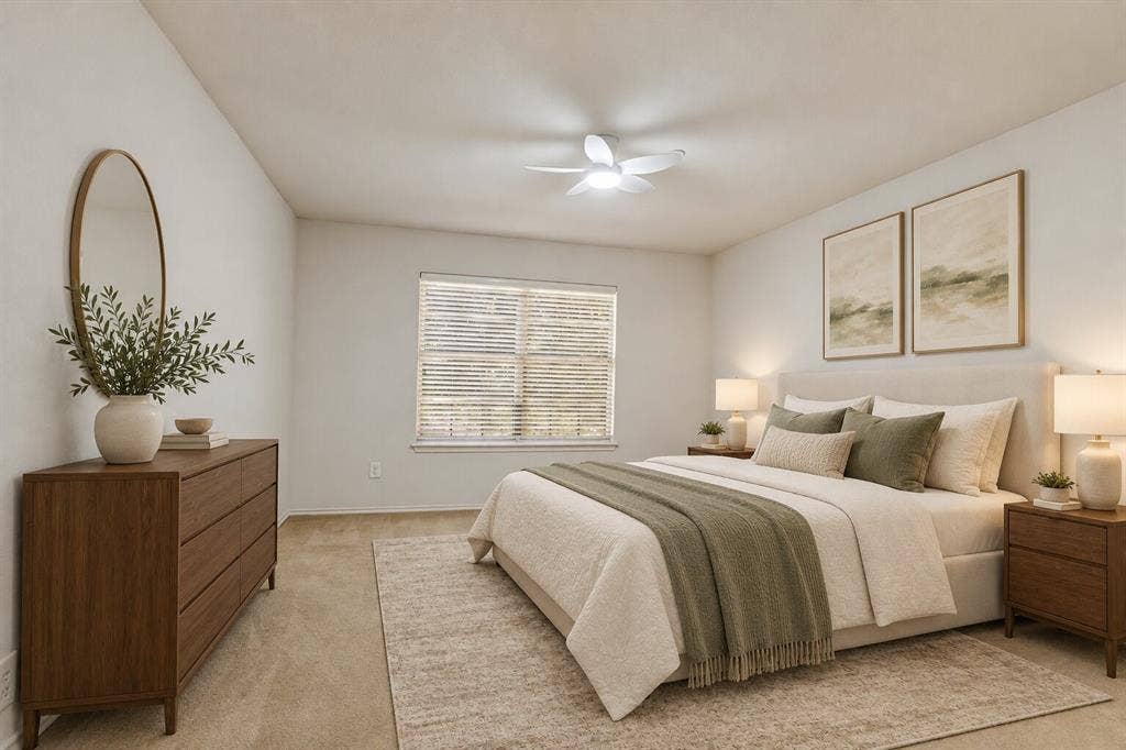 Neutral interior featuring carpeting, a multi-blade ceiling fan with integrated lighting, and window blinds