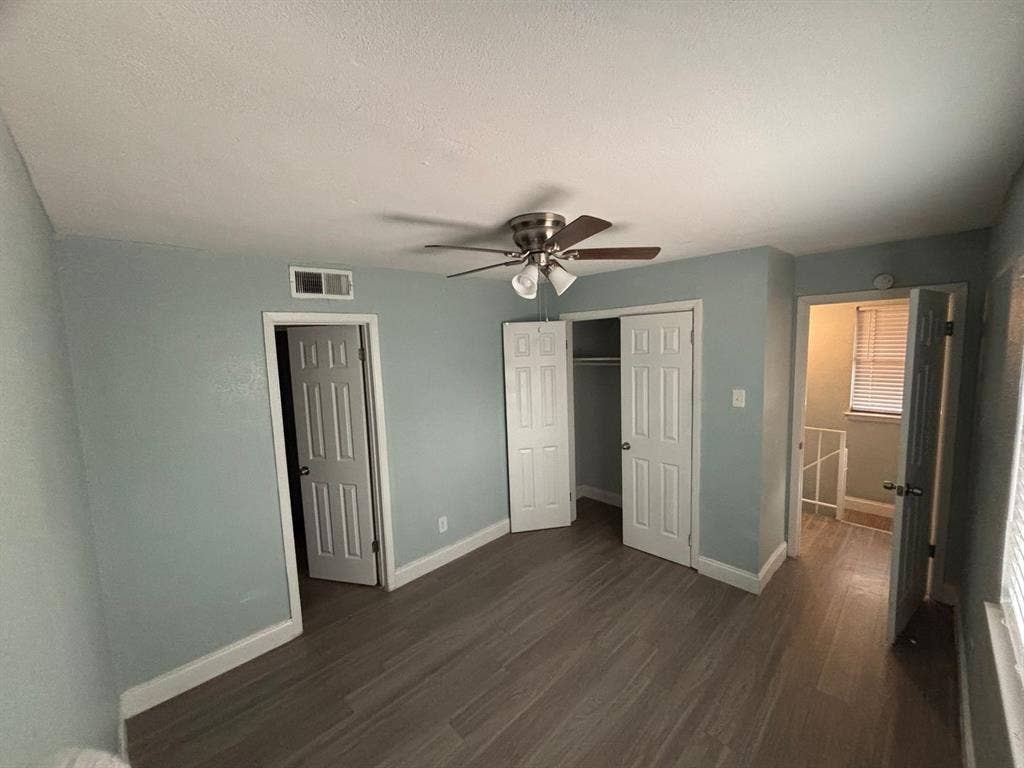 301 Rolston Road, #307-103, Irving, TX 75060 Wood-finish flooring, six-panel interior doors, and a ceiling-mounted light fixture with a fan