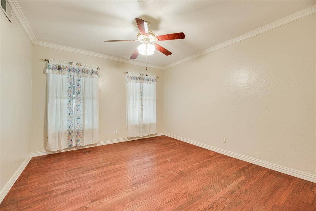 1572 Gillette Circle, Dallas, TX 75217 Interior room featuring wood-finish flooring, crown molding, and a central ceiling fan with integrated light fixture
