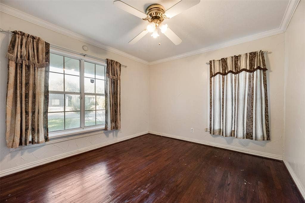 1572 Gillette Circle, Dallas, TX 75217 Room featuring wood-finish flooring, crown molding, multi-pane windows, and a ceiling fan with integrated lighting