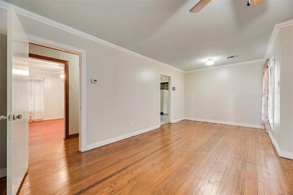 1572 Gillette Circle, Dallas, TX 75217 Interior space featuring wood-finish flooring, crown molding, and a ceiling fan