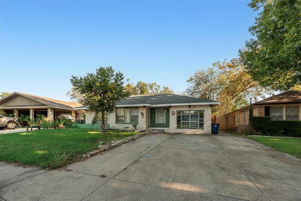1572 Gillette Circle, Dallas, TX 75217 Single-story residence featuring a light-toned masonry exterior, a multi-pane grid window, and a concrete driveway