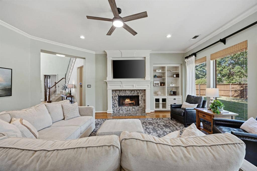 Enjoy this space with a comfy couch, a warm fire and a wall of windows.