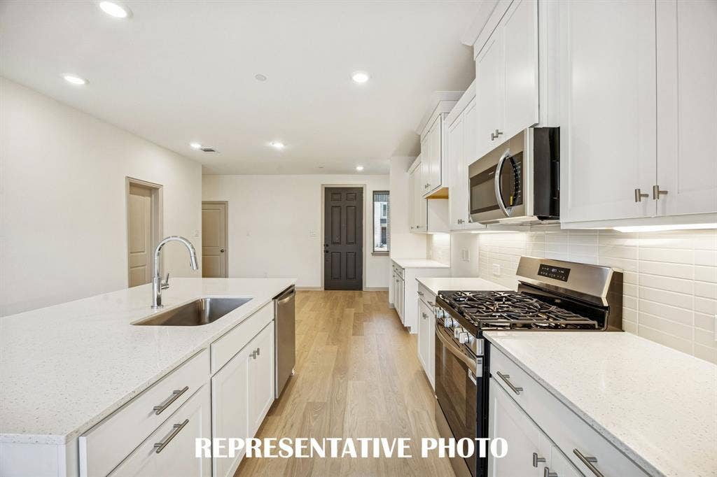 3574 Pierce Lane, Grand Prairie, TX 75052 Beautiful cabinetry, gorgeous countertops and classic backsplash effortlessly combine with contemporary stainless steel to create your dream kitchen! REPRESENTATIVE PHOTO
