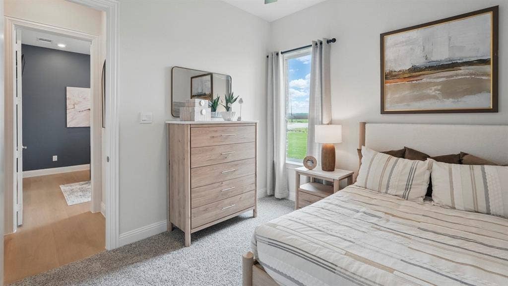 Neutral wall tones, carpeting, and a window with exterior exposure