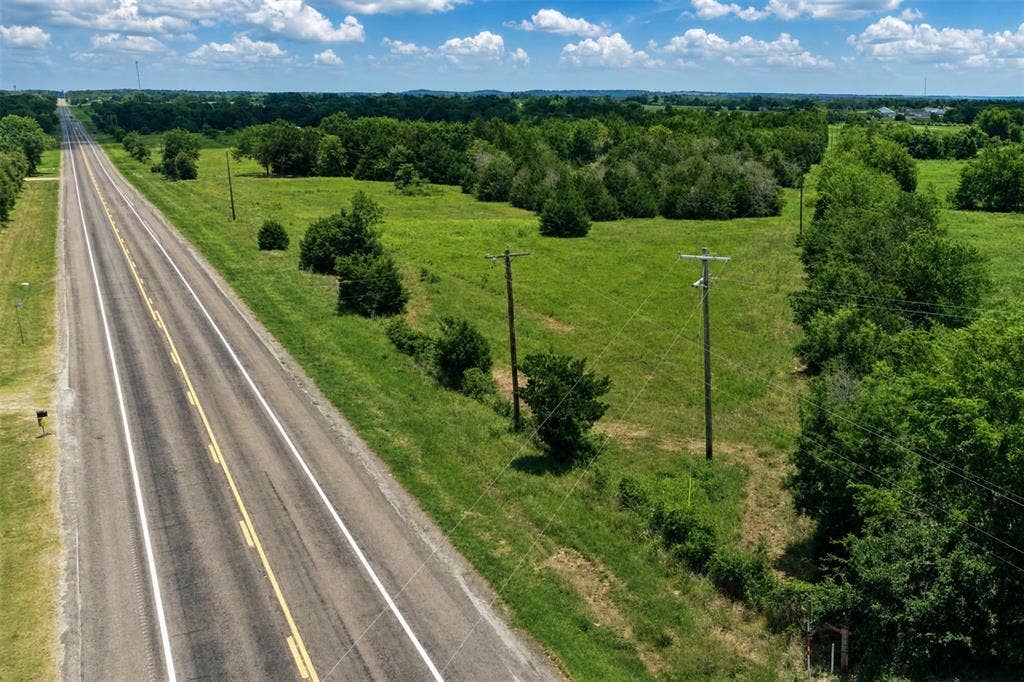 Lot 1 Morgan Road, Italy, TX 76651 Expansive acreage featuring mature trees, native grasses, and paved road frontage