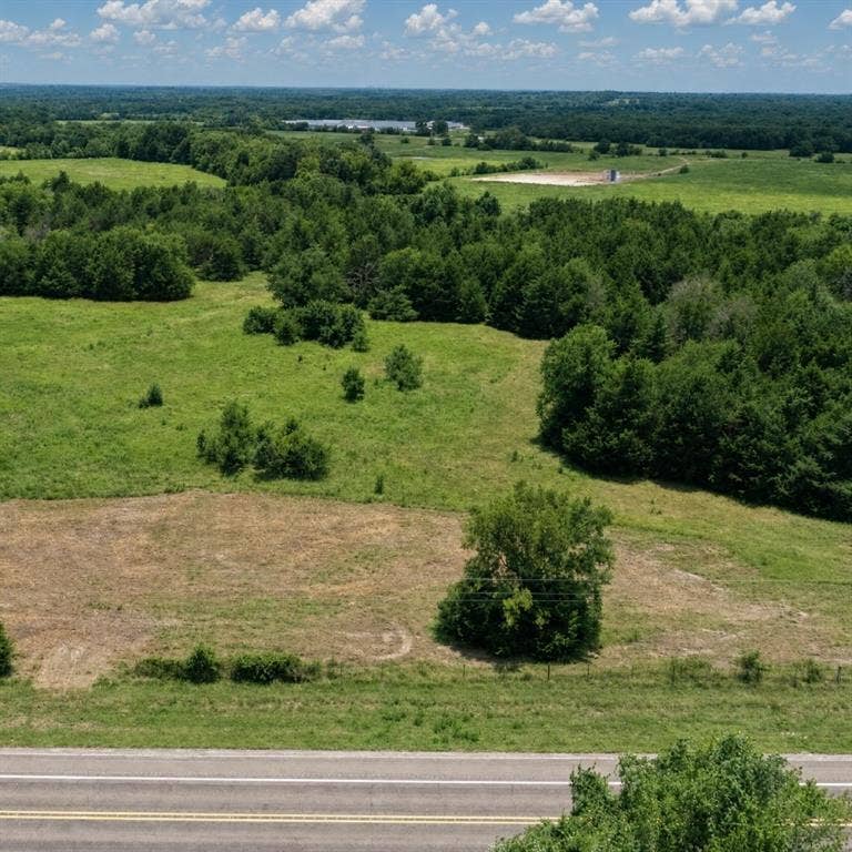 Lot 1 Morgan Road, Italy, TX 76651 Expansive acreage featuring cleared pasture, mature tree lines, and paved road frontage